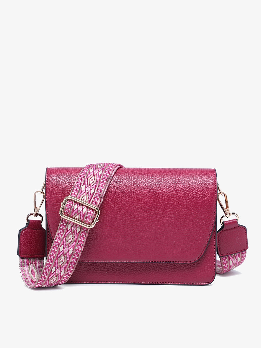 The Noah Flapover Crossbody with Guitar Strap offers a blend of functionality and style, perfect for your daily adventures. Featuring an adjustable and removable guitar strap, this bag offers versatility in carrying options, allowing you to wear it comfortably as a crossbody or remove the strap for a sleek clutch style.